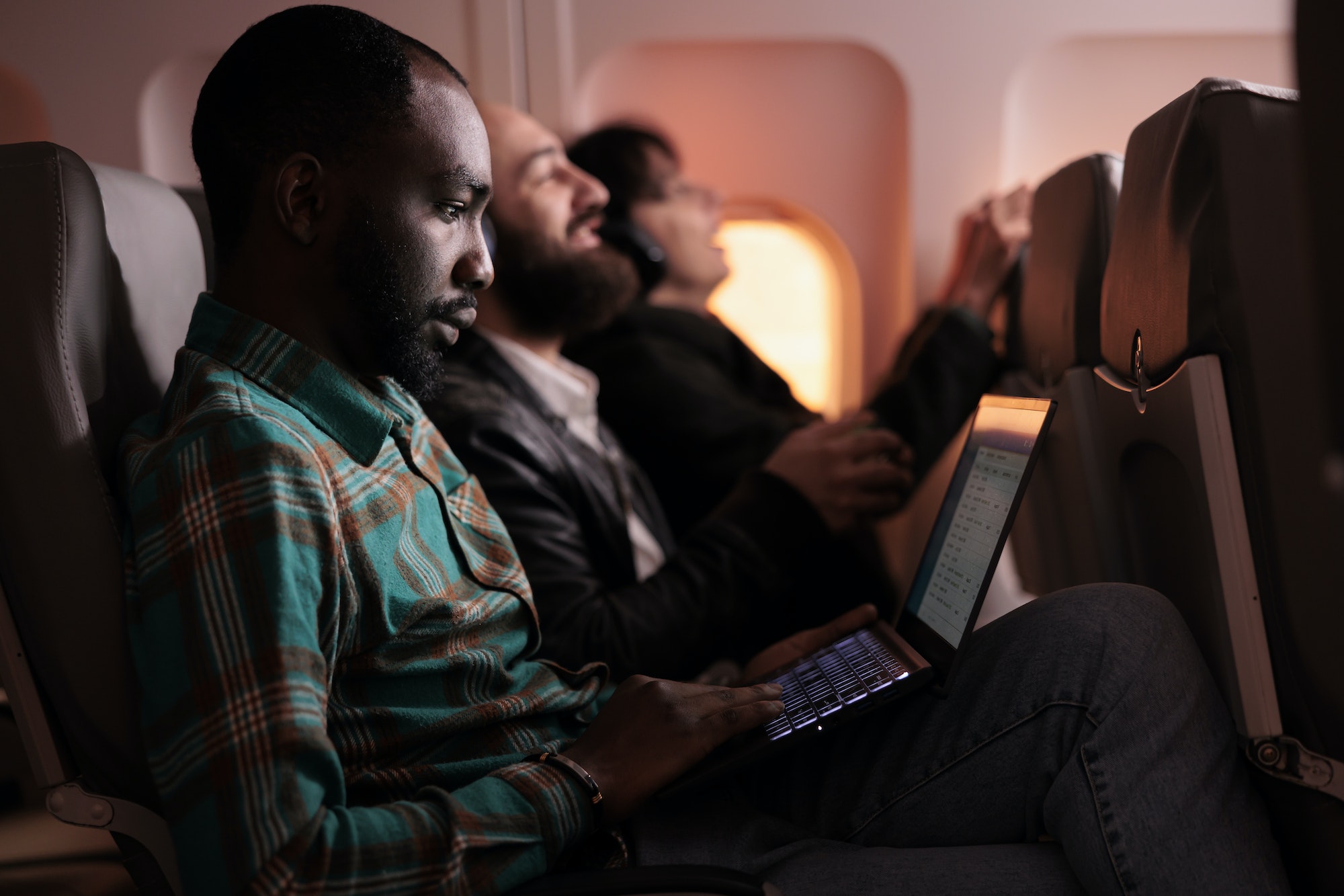 African american man travelling abroad by airplane on international flight